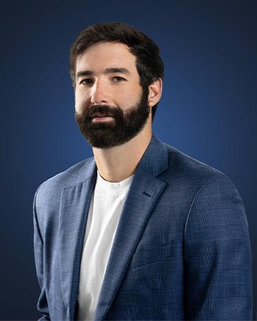 Dylan Pond wears a t shirt under a dark suit