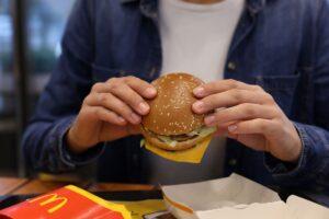 Photo of a customer eating a McDonald's hamburger potentially contaminated with E. coli.