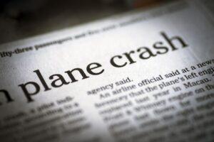 Newspaper emphasizing the headline "plane crash."