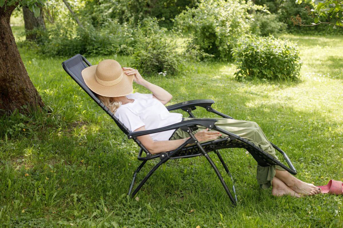 Image of a woman lounging in a zero gravity chair that could potentially be defective.