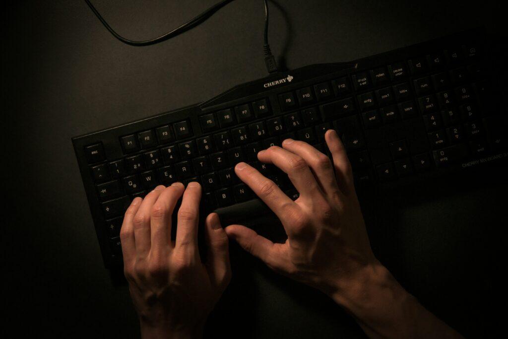 A person's hands typing on a keyboard, focused on their work or task at hand.