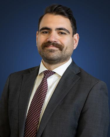 Attorney Alan Reyderman, wearing a dark suit and a dark red tie