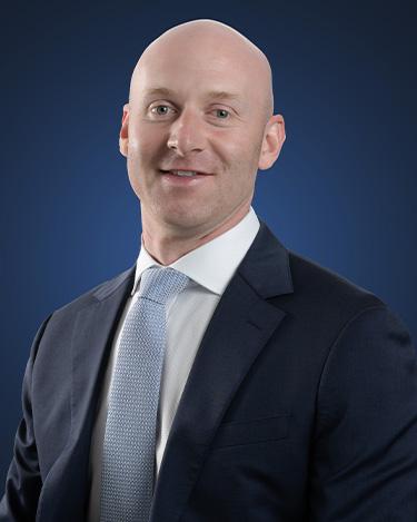 Attorney Francis Smith, wearing a dark suit with a light blue tie