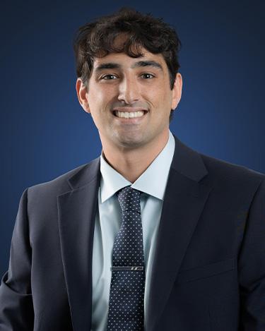 Hunter Phillips, wearing a dark suit and dark tie
