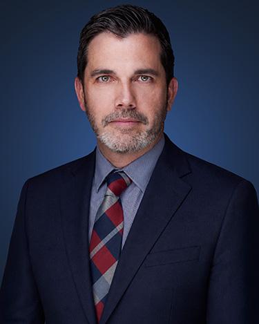 Attorney Gabe Spooner wearing a dark suit