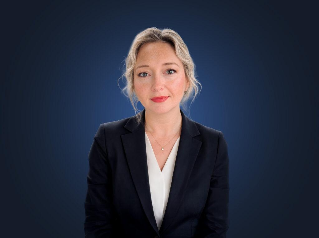 Attorney Aryna Anderson, wearing a dark suit in front of a dark blue background