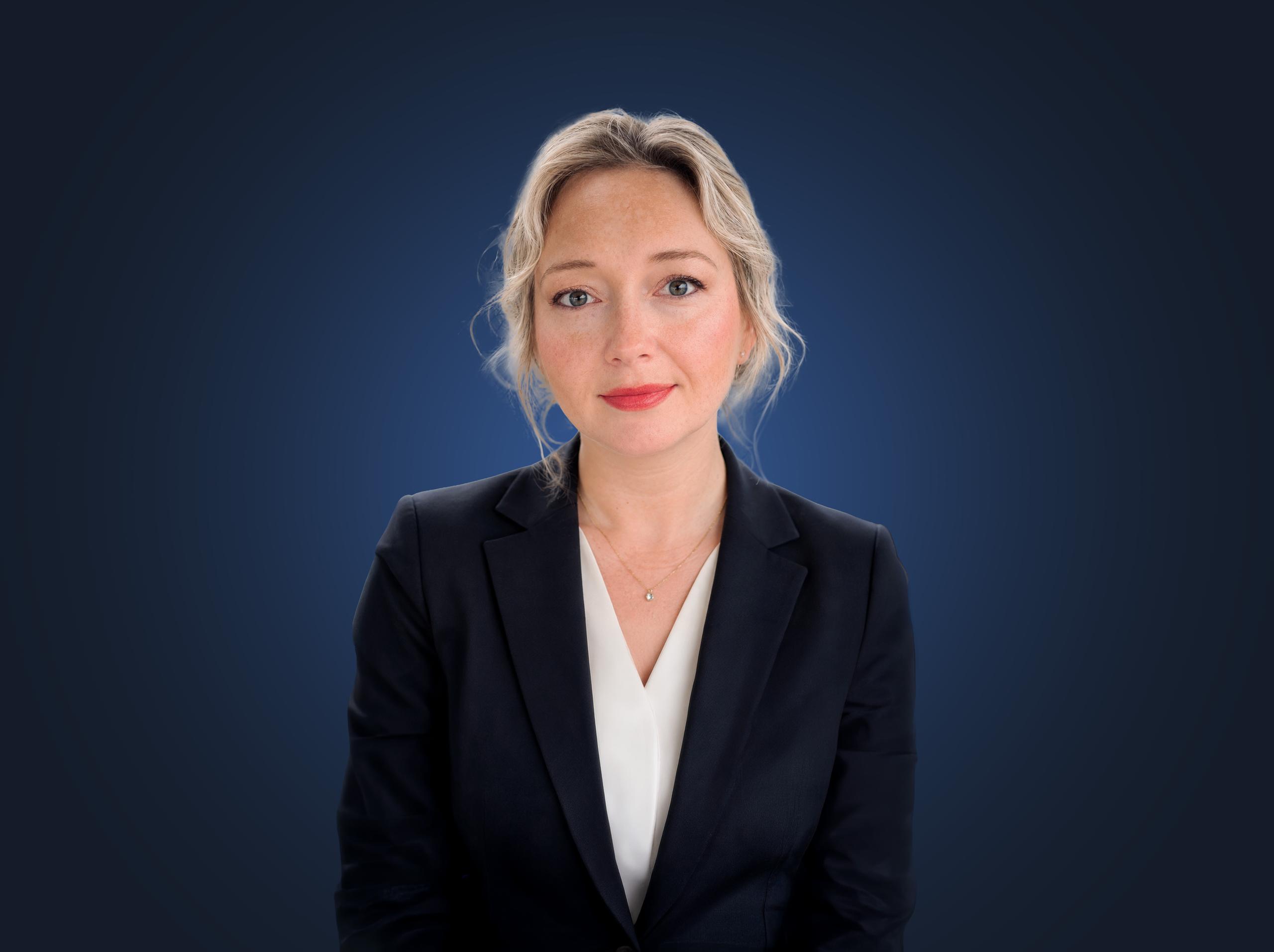 Attorney Aryna Anderson, wearing a dark suit in front of a dark blue background