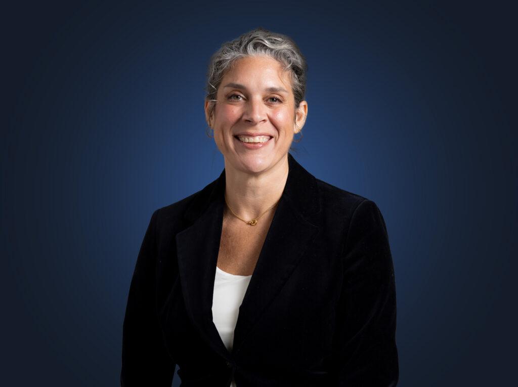 Attorney Nicola Serianni, wearing a dark suit in front of a dark blue background