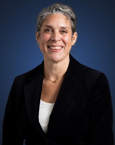 Attorney Nicola Serianni, in a dark suit against a dark blue background